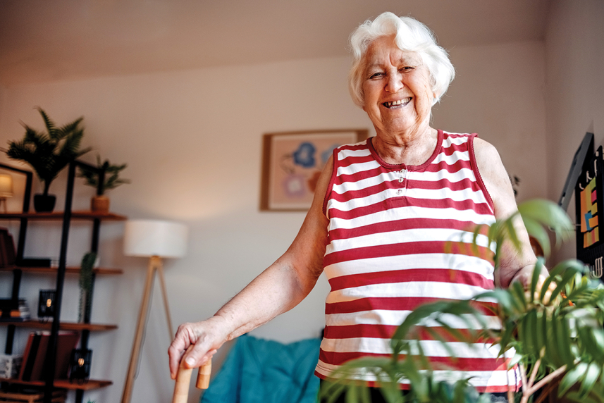 An elderly woman walking in her home