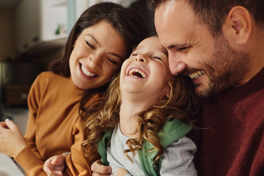 Parents are laughing with their child