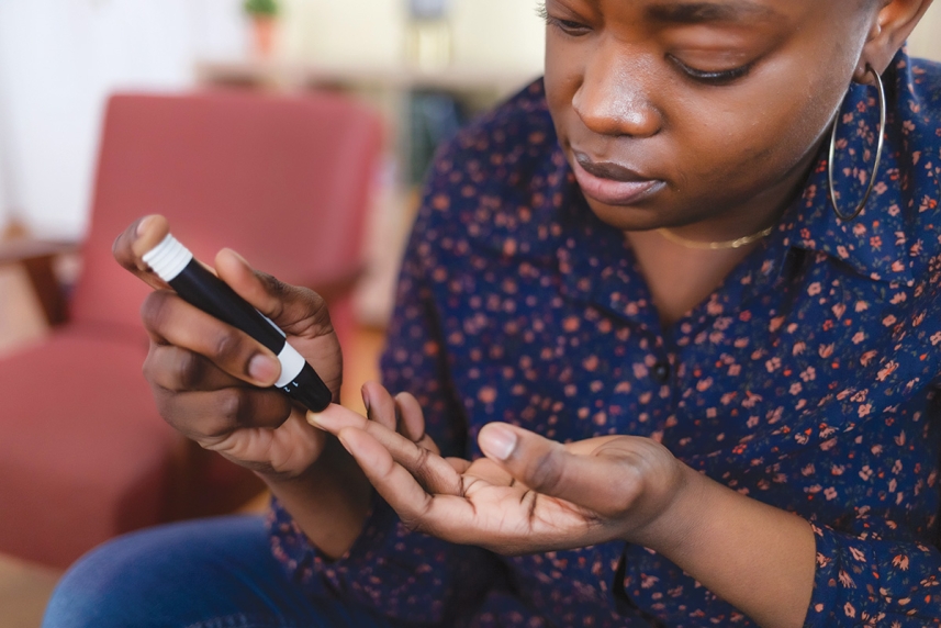 A person testing their blood glucose level