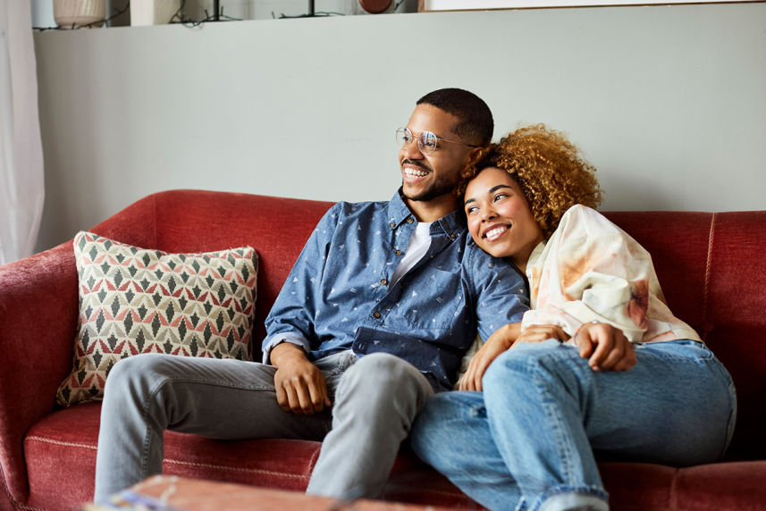 A couple sitting on a couch.