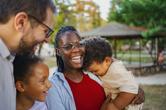 A family outside and laughing.