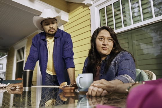 Two adults at a table talking to a loved one