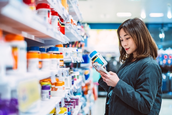 A woman looks at medicines in a drug store