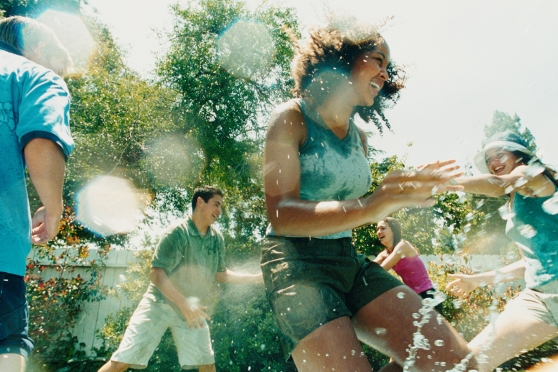 Teenagers playing outside in water